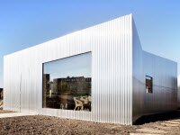 Rebel Дом с фасадом из гофрированного алюминия отражает цвета его окрестностей