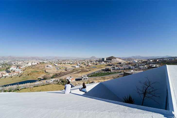 Современный дом погребенный частично в пустыне Чиуауа, сохраняет прохладу