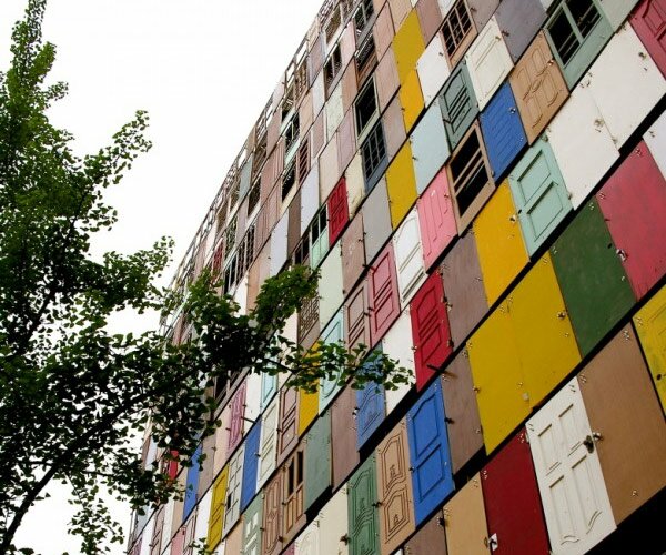 Фасад 10 этажного здания 1000 старых дверей